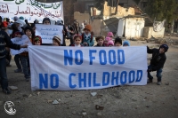 Scores of women and children joined a silent protest this morning in the besieged city of Daraya